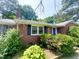 Well-maintained brick home with dark shutters, a blue front door, and beautiful landscaping for great curb appeal at 518 Heater Dr, Cary, NC 27511
