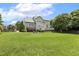 Expansive backyard with lush green grass and mature trees, ideal for recreation and relaxation at 5516 Colonial Oaks Dr, Apex, NC 27539