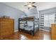 Bedroom with hardwood floors, a ceiling fan, and a wooden bunk bed setup perfect for  at 5516 Colonial Oaks Dr, Apex, NC 27539