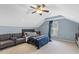 Cozy bedroom featuring a sloped ceiling, a ceiling fan, a comfortable bed and an accent chair at 5516 Colonial Oaks Dr, Apex, NC 27539