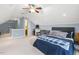 Spacious bedroom featuring a sloped ceiling, a ceiling fan, a comfortable bed, and a built-in desk at 5516 Colonial Oaks Dr, Apex, NC 27539