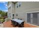 Wooden deck adjacent to the house, featuring a dining table and sliding doors leading inside at 5516 Colonial Oaks Dr, Apex, NC 27539