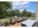 Spacious wooden deck featuring comfortable seating, an umbrella, and a dining table with views of the backyard at 5516 Colonial Oaks Dr, Apex, NC 27539