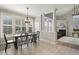 Bright dining area adjacent to the kitchen with large windows, fireplace, and an open floor plan at 5516 Colonial Oaks Dr, Apex, NC 27539