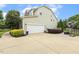 Exterior view of the home featuring an attached garage, landscaping, and a basketball hoop in the driveway at 5516 Colonial Oaks Dr, Apex, NC 27539