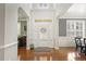 Bright foyer features gleaming hardwood floors and elegant trim, creating a welcoming entrance at 5516 Colonial Oaks Dr, Apex, NC 27539