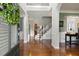 Inviting foyer with hardwood floors, staircase, and decorative arched entryways at 5516 Colonial Oaks Dr, Apex, NC 27539