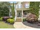 Welcoming front porch with stone steps, decorative plants, and a charming entrance at 5516 Colonial Oaks Dr, Apex, NC 27539