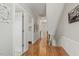 Upstairs hallway featuring hardwood floors and access to multiple rooms at 5516 Colonial Oaks Dr, Apex, NC 27539