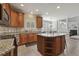 Spacious kitchen with granite countertops, stainless steel appliances and a large center island with bar seating at 5516 Colonial Oaks Dr, Apex, NC 27539