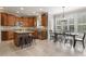 Open kitchen with a center island, wooden cabinets, granite countertops, stainless steel appliances and dining area at 5516 Colonial Oaks Dr, Apex, NC 27539
