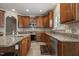 Open kitchen featuring granite countertops, wood cabinets and stainless steel appliances at 5516 Colonial Oaks Dr, Apex, NC 27539