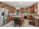 Spacious kitchen featuring stainless steel appliances, wooden cabinets and a large island at 5516 Colonial Oaks Dr, Apex, NC 27539