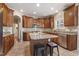 Bright kitchen with granite counters, stainless appliances, wooden cabinets, and center island at 5516 Colonial Oaks Dr, Apex, NC 27539