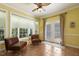Inviting sun room with large windows, tile flooring, and cozy seating area at 5516 Colonial Oaks Dr, Apex, NC 27539