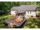 Spacious backyard featuring a wooden deck, screened porch and fire pit area, ideal for outdoor gatherings and relaxation at 589 John Mitchell Rd, Youngsville, NC 27596