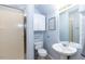 All-white bathroom featuring a shower, toilet, and pedestal sink at 589 John Mitchell Rd, Youngsville, NC 27596