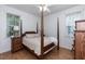 Bedroom featuring a four-poster bed and hardwood floors at 589 John Mitchell Rd, Youngsville, NC 27596