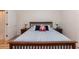 Bedroom with bed, side tables, lamps, and neutral walls at 589 John Mitchell Rd, Youngsville, NC 27596