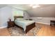 Bedroom features a large window, hardwood floors, and neutral gray paint at 589 John Mitchell Rd, Youngsville, NC 27596