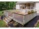 Beautiful wooden deck with white railings and decorative landscaping, perfect for outdoor entertaining and relaxation at 589 John Mitchell Rd, Youngsville, NC 27596