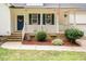 Charming front porch with a decorated blue door, white railings, and manicured landscaping, creating a warm curb appeal at 589 John Mitchell Rd, Youngsville, NC 27596