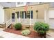 Cozy front porch featuring blue shutters, decorative hanging plants, and a charming, welcoming atmosphere at 589 John Mitchell Rd, Youngsville, NC 27596