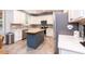 Modern kitchen with stainless steel appliances, white cabinets, and central island with butcher block top at 589 John Mitchell Rd, Youngsville, NC 27596