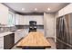 Stylish kitchen featuring stainless appliances, white cabinetry, and a butcher block island at 589 John Mitchell Rd, Youngsville, NC 27596