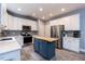 Well-appointed kitchen boasts stainless steel appliances, an island, and ample cabinet space at 589 John Mitchell Rd, Youngsville, NC 27596