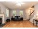 Inviting living room with a cozy fireplace, and natural light from the windows at 589 John Mitchell Rd, Youngsville, NC 27596