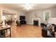 Spacious living room featuring hardwood floors, fireplace, and open access to the dining room at 589 John Mitchell Rd, Youngsville, NC 27596