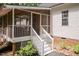 Stairs provide access to the cozy screened-in porch at 589 John Mitchell Rd, Youngsville, NC 27596