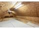 Large unfinished attic space with wood floors, shelving and a ceiling fan at 589 John Mitchell Rd, Youngsville, NC 27596