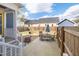 A fenced backyard features a patio with seating, a fire pit and blue skies at 595 E Cabarrus St, Raleigh, NC 27601