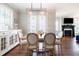 Bright dining area with a large wooden table, comfortable seating, and a modern chandelier at 595 E Cabarrus St, Raleigh, NC 27601