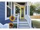 Charming front porch with a yellow door and decorative metal sunflowers at 595 E Cabarrus St, Raleigh, NC 27601