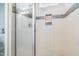 Modern shower featuring tiled walls, recessed shelf, and sleek glass door at 595 E Cabarrus St, Raleigh, NC 27601