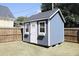 A backyard storage shed is painted blue and accented with white trim at 595 E Cabarrus St, Raleigh, NC 27601