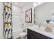 Bathroom features a tub, shower, toilet, vanity with sink, mirror and a colorful shower curtain at 611 Callan View Ave, Wake Forest, NC 27587