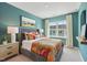 Bright bedroom featuring a comfortable bed with decorative pillows, a nightstand, and a window with a view at 611 Callan View Ave, Wake Forest, NC 27587