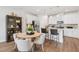 Modern kitchen featuring stainless steel appliances, white cabinetry, and a cozy breakfast bar with seating at 611 Callan View Ave, Wake Forest, NC 27587
