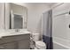 Bathroom featuring a modern vanity with white countertops, a toilet, and a shower-tub combination with a shower curtain at 629 Newlyn Dr, Raleigh, NC 27606