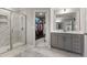 Bright bathroom featuring a glass shower and a vanity, with a view into the walk-in closet at 629 Newlyn Dr, Raleigh, NC 27606