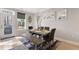 Bright dining area with wood table, bench seating, stylish decor, and a door leading to the outside at 629 Newlyn Dr, Raleigh, NC 27606