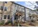 A view of the rear exterior of a multi-unit house, with wooden decks and some AC units near the back at 629 Newlyn Dr, Raleigh, NC 27606