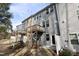 The exterior view of a multi-unit home, featuring multiple wooden decks and some AC units in the back at 629 Newlyn Dr, Raleigh, NC 27606