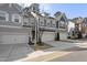 The exterior view of some townhouses with garages and driveways on a sunny day at 629 Newlyn Dr, Raleigh, NC 27606