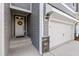 Inviting entryway with a classic door, brick accents, and an attached garage at 629 Newlyn Dr, Raleigh, NC 27606