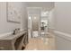 Hallway with light wood flooring, neutral paint, and an open view to the kitchen at 629 Newlyn Dr, Raleigh, NC 27606